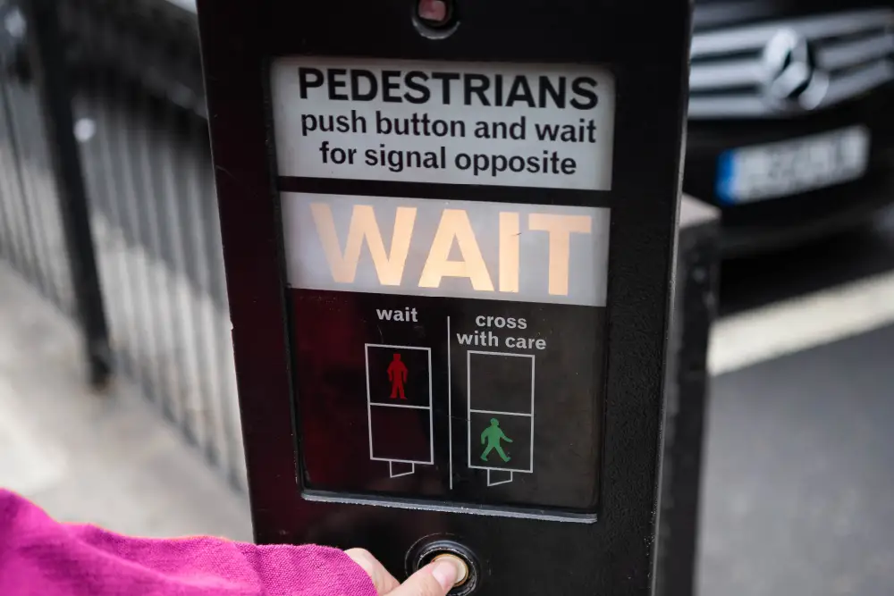 someone pushing the button for a road crossing
