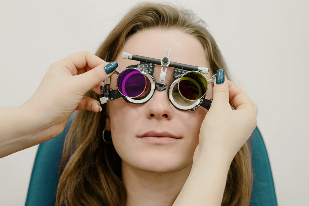 A women having her eyes tested using glasses with colourful lenses