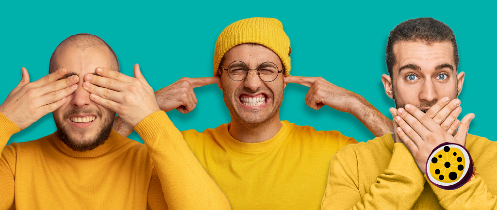 Three men in yellow long sleeved t shirts: one covers his eyes, another covers his ears, and the third covers his mouth, resembling the see no evil, hear no evil, speak no evil concept