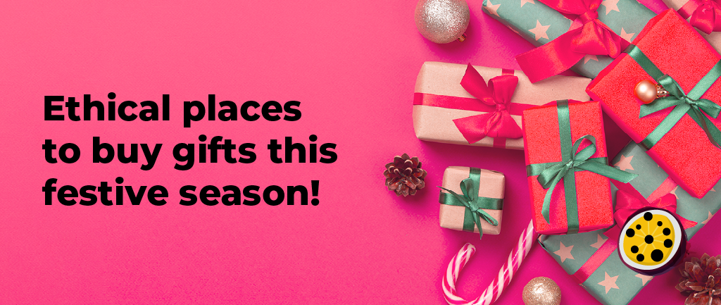 Bold black text reading Ethical places to buy gifts this festive season on a pink background, with presents, golden baubles, and pinecones on the right