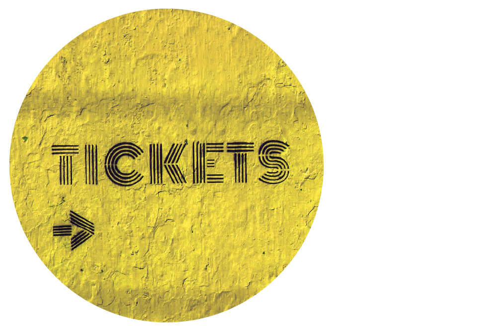 a yellow textured wall with an arrow pointing to the right and the word 'tickets' spray-painted in bold, black lettering.