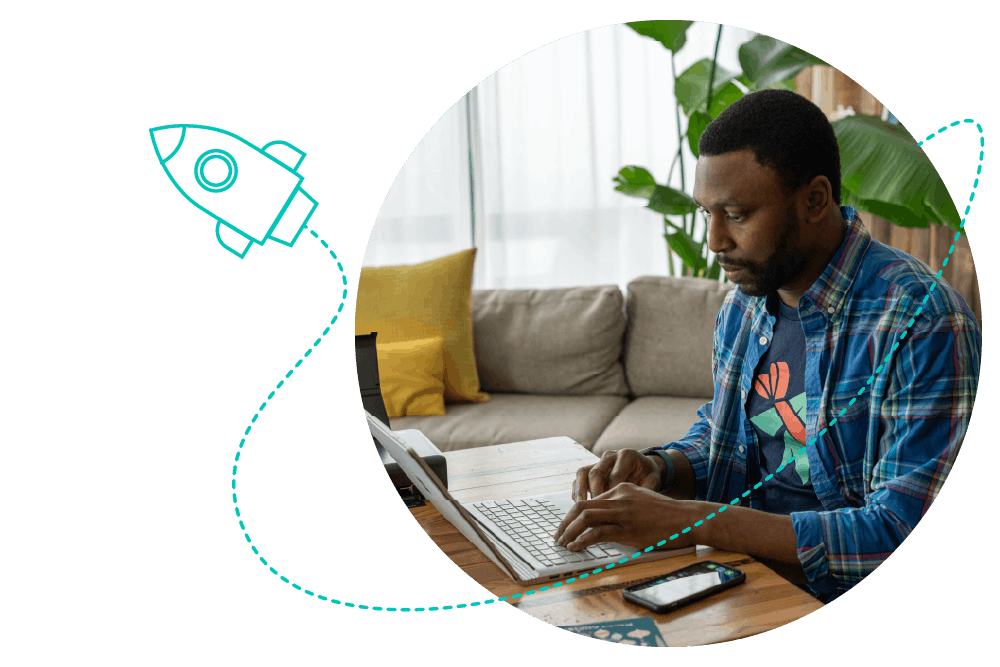 a person using a laptop computer with a mobile phone on the desk in front of them. A teal rocketship graphic launches upwards, leaving a trail
