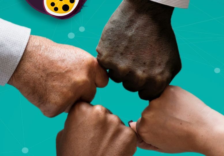 close up of the four hands of people of different skin tones bumping fists