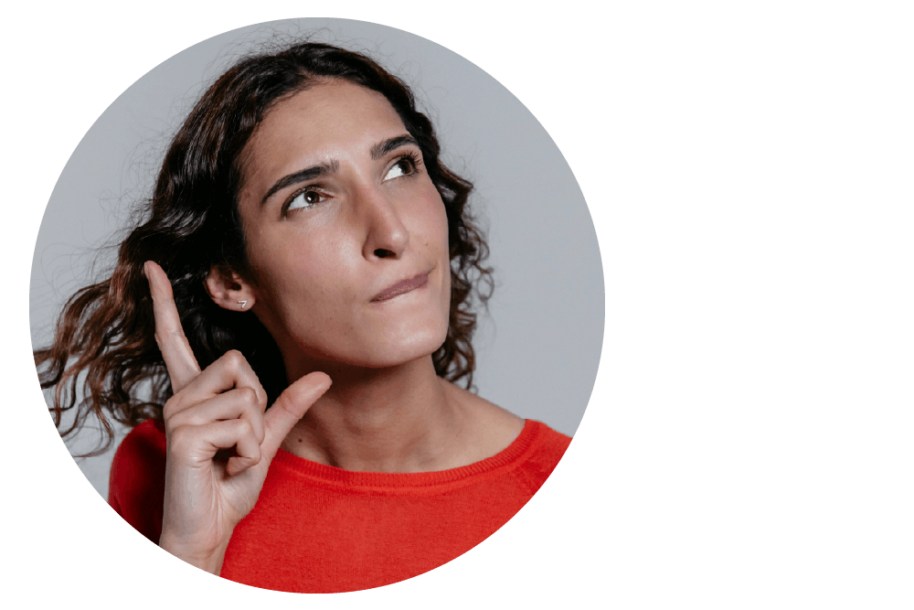 a person looking upwards thoughtfully while signing with one hand close to their face.