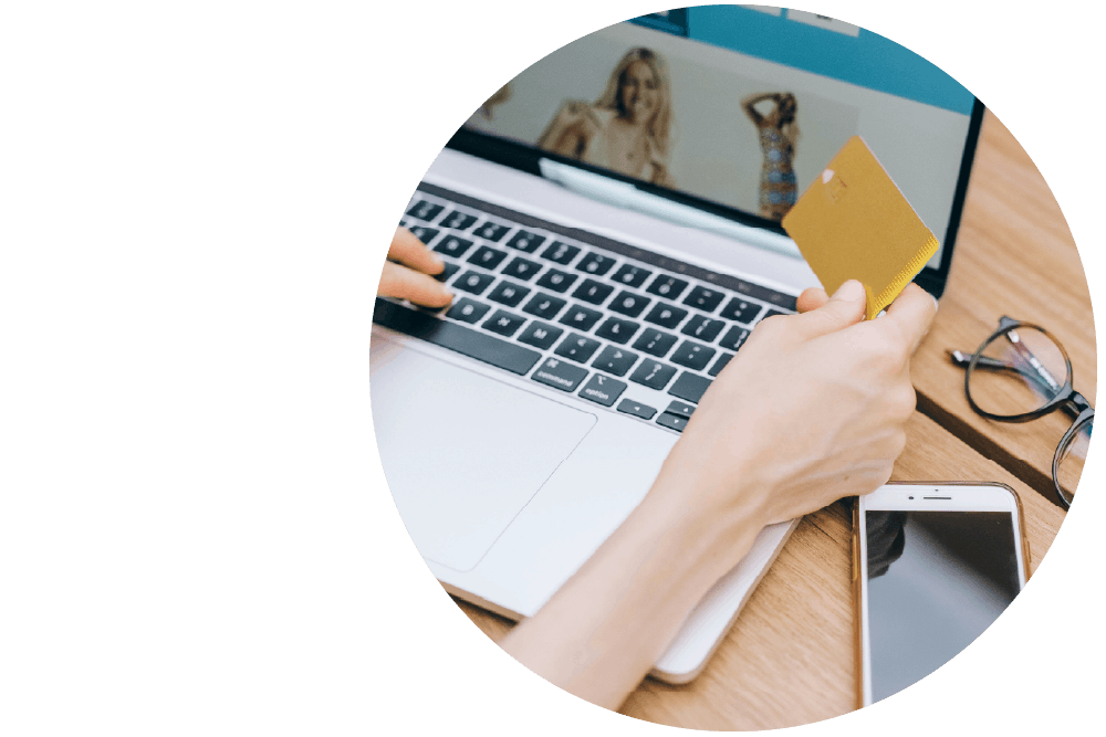 A person entering their credit card details at a laptop computer.
