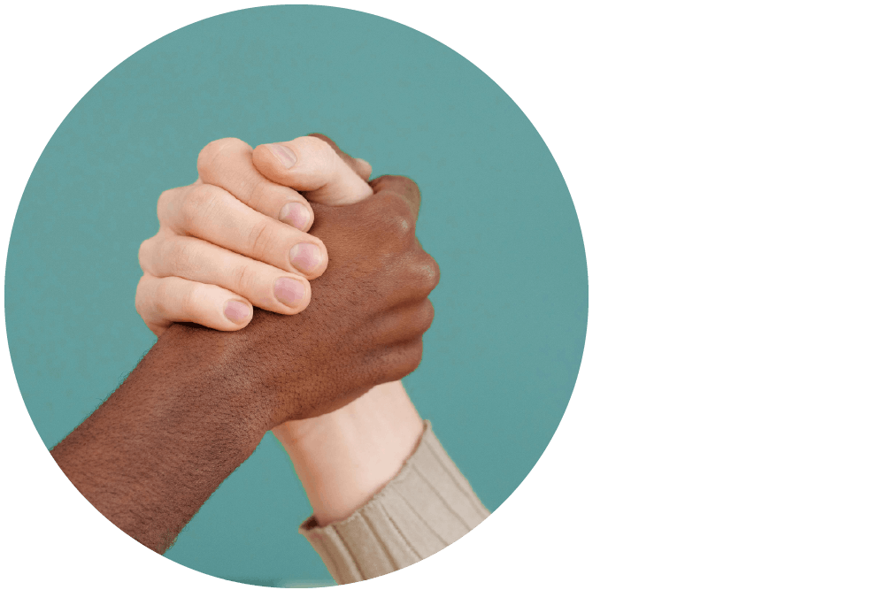 Two hands with different skin tones clasped together.
